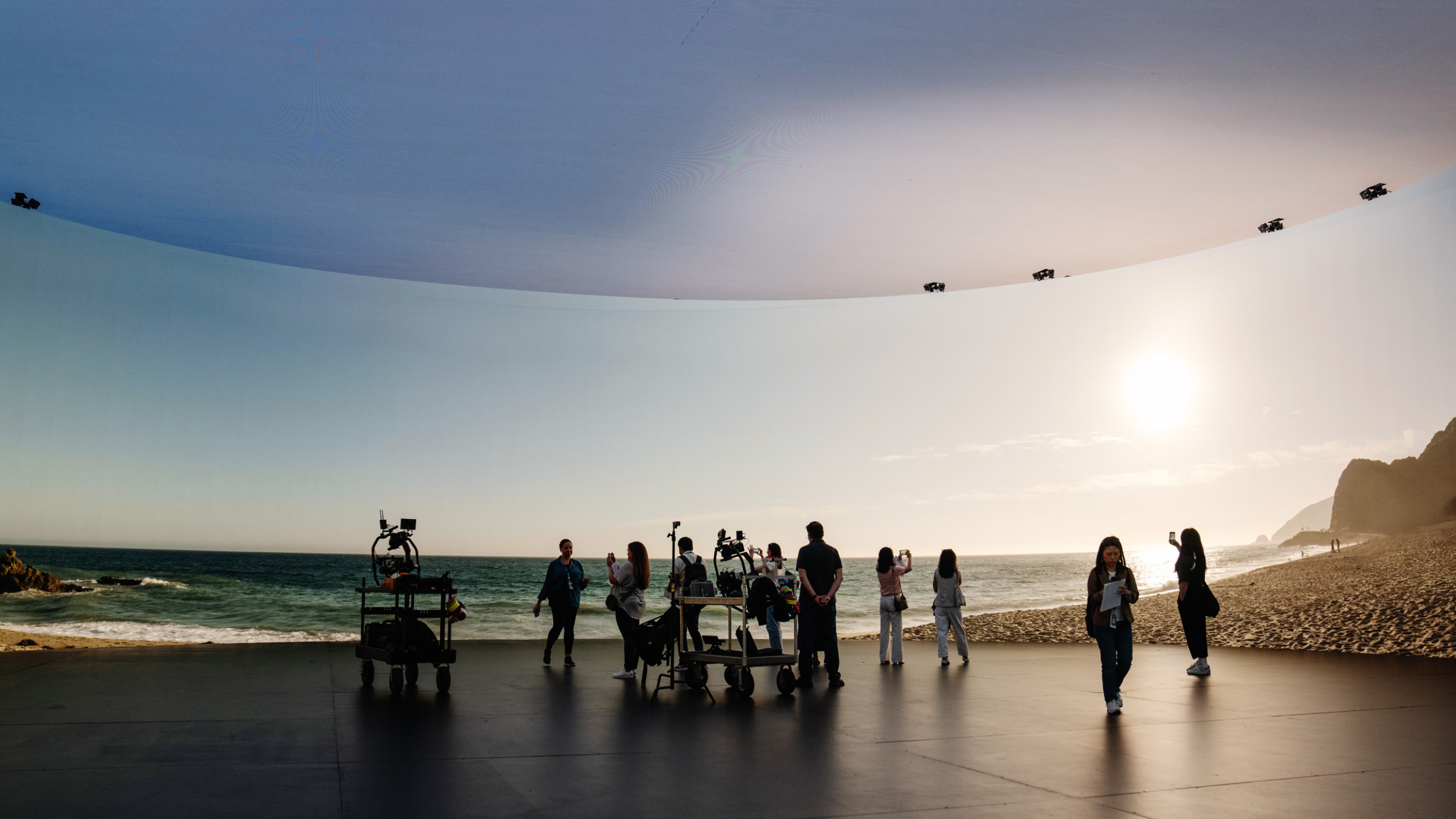 Stage 15 LED volume displaying a beach environment behind a film crew
